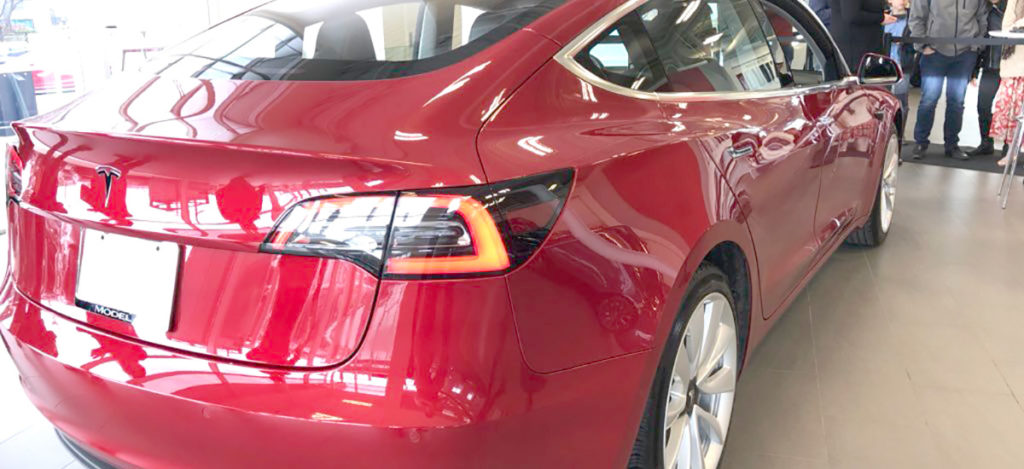 Red Tesla Model 3 at Tesla Store Montreal, Canada