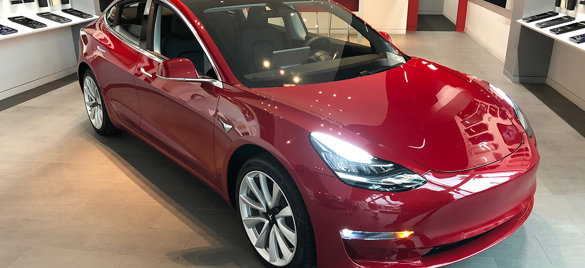 Red Tesla Model 3 at the Tesla Design Studio in Jacksonville, FL