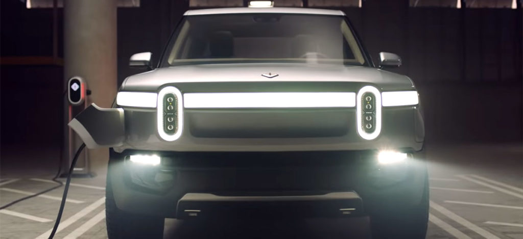 Rivian R1T Electric Pickup Truck - Front view with charge port plugged-in