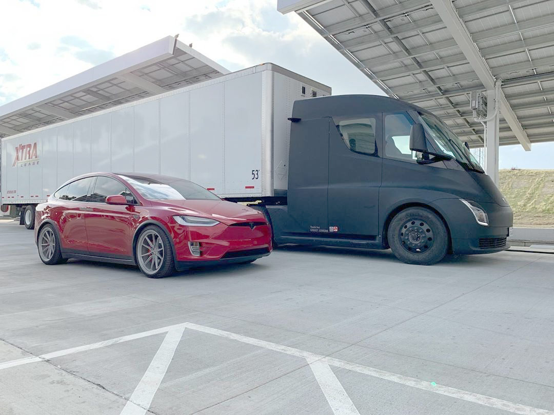 Black Tesla Semi Truck at the Kettleman City Supercharger with a Model X.