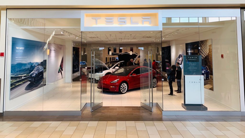 New Tesla store with a red Model 3 and white Model X