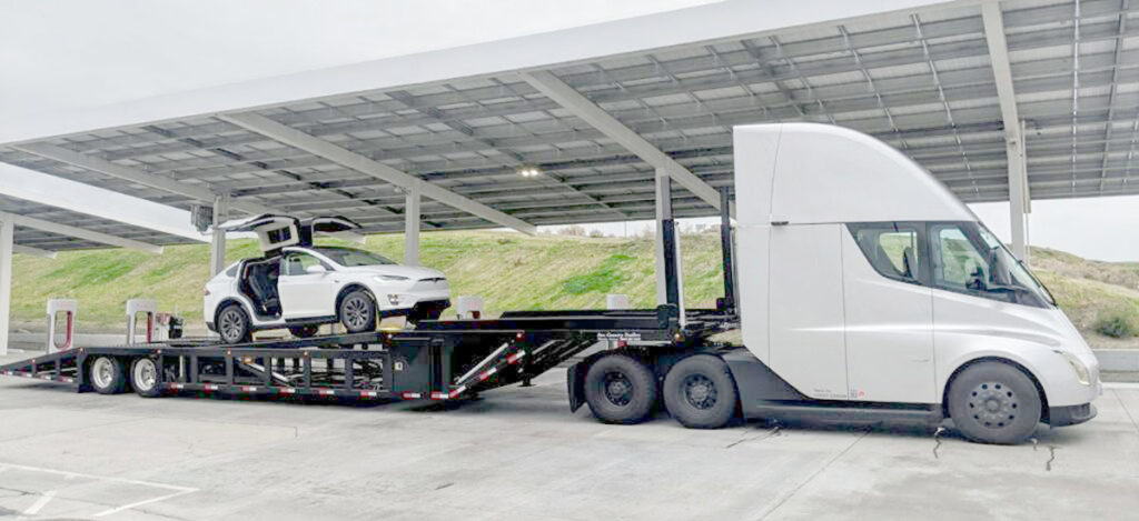 Tesla Semi Truck carrying a Tesla Model X on empty trailer