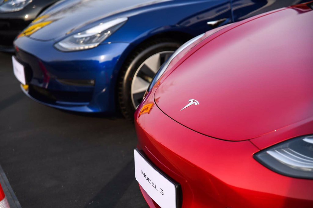 Red and Blue Tesla Model 3 at the Goldenport Race Circuit in Beijing, China