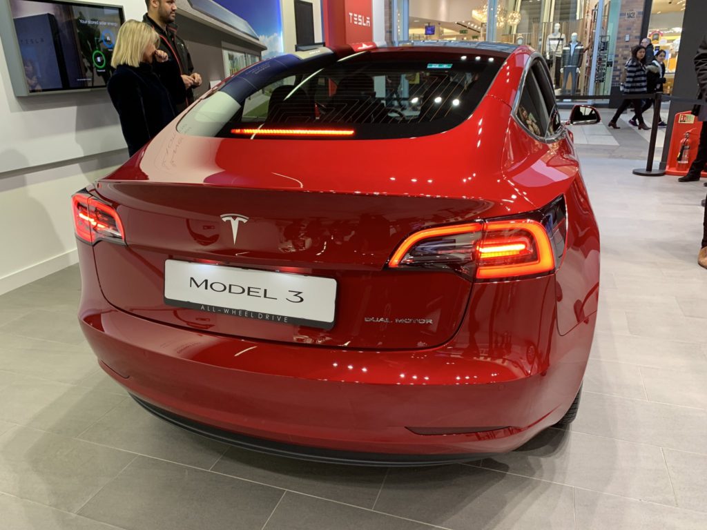 Red Tesla Model 3 on display in the UK - Rear View