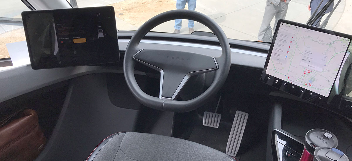 Tesla Semi interior photo showing steering and dual screens