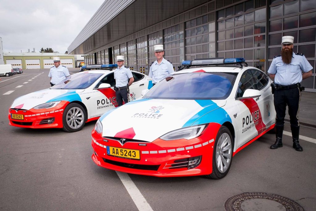 Two Tesla Model S of the Luxembourg Police pose for a picture with police officers.
