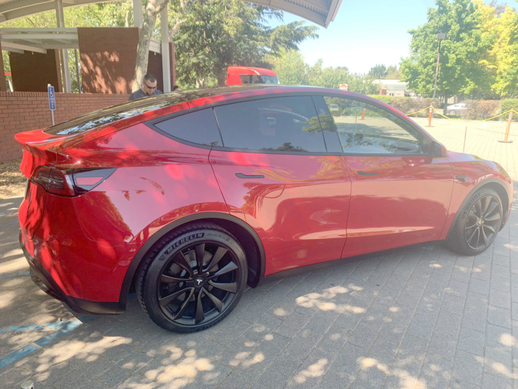Red Tesla Model Y at the 2019 Tesla Shareholder Meeting - Side View Profile