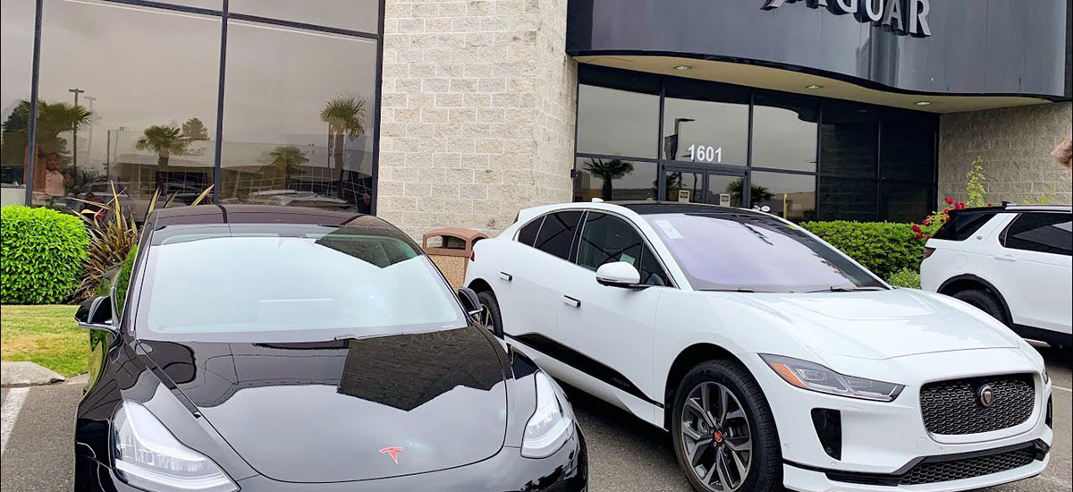 Tesla Model 3 parked outside Jaguar dealership, Sentry Mode records curious Jaguar salesmen checking out the Model 3.