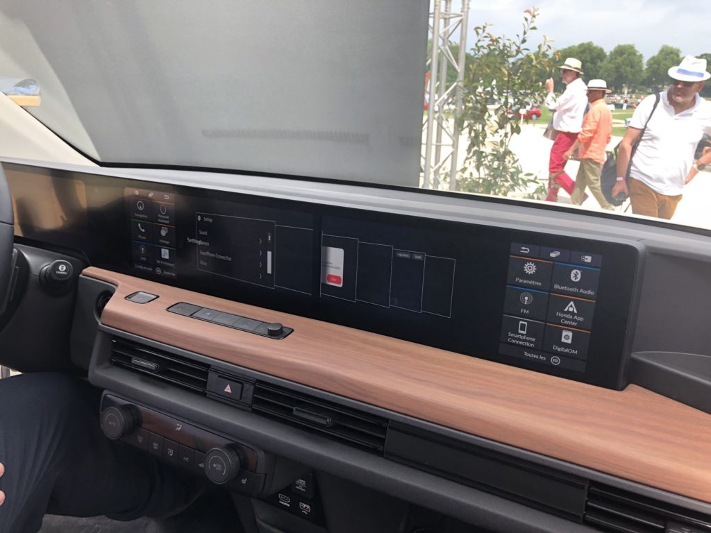 Honda e Prototype Interior - center touchscreen, steering wheel, dashboard, side mirror cameras.
