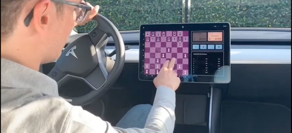 Fabiano Caruana challenges a Tesla Model 3 to a game of chess.
