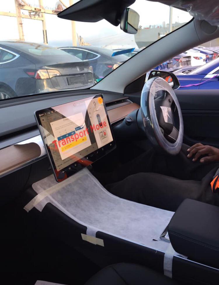 RHD Tesla Model 3s spotted at the Port of San Francisco Pier 80. Interior picture shows 'Transport Mode' written on the center touchscreen in big red font.