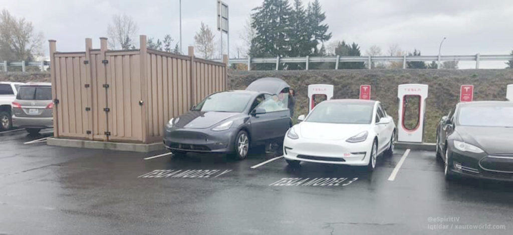Tesla Model 3 and Model Y side-by-side at a Supercharger station in California.