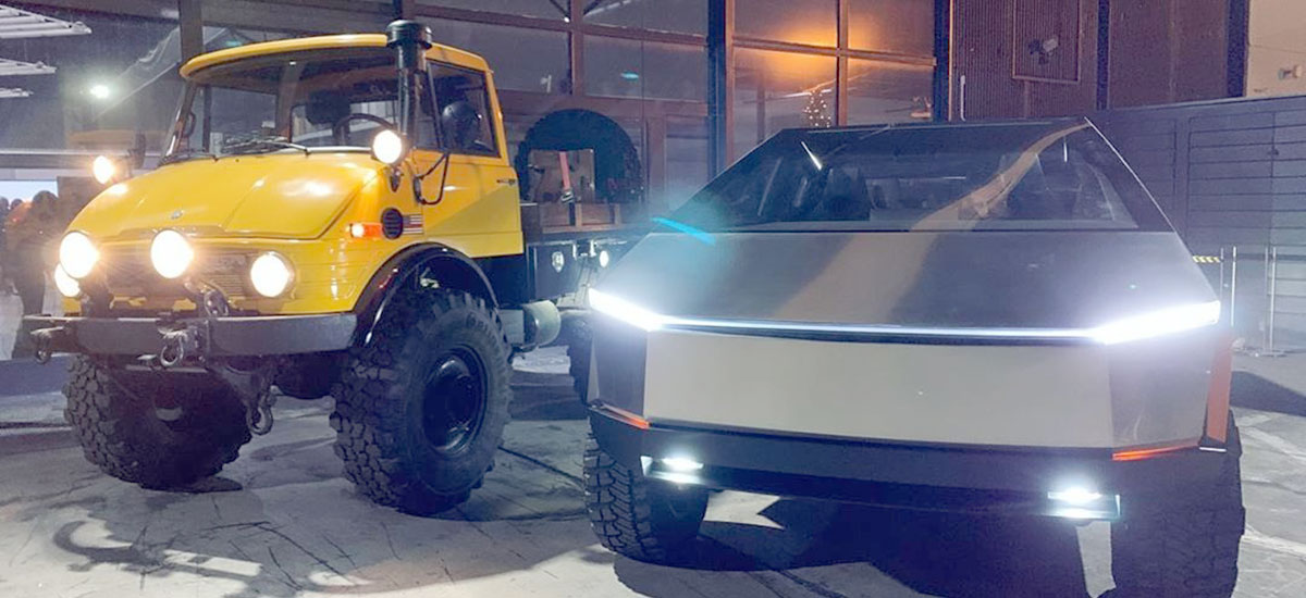 Tesla Cybertruck standing besides a Mercedes Benz Unimog Truck.
