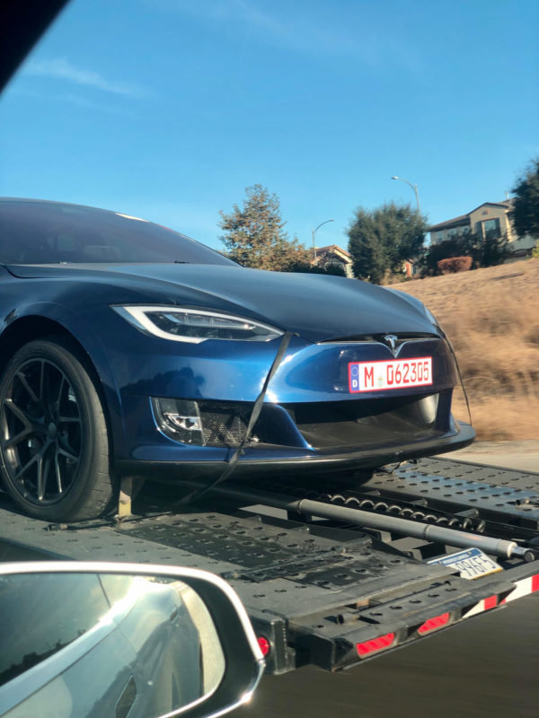 Tesla Model S Plaid prototypes returning home on a car carrier trailer. Blue one in closeup.