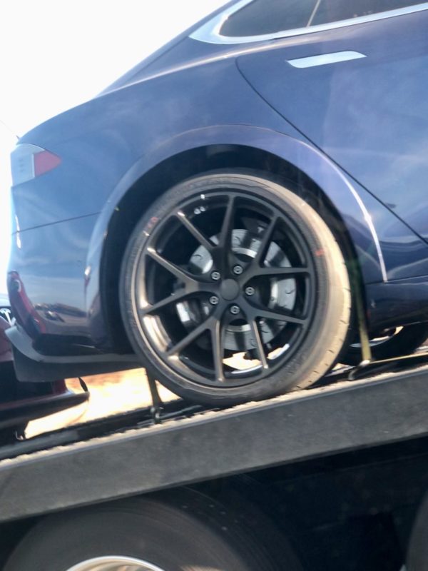 Tesla Model S Plaid prototypes returning home, close look at the black wind turbine wheel of the blue car.