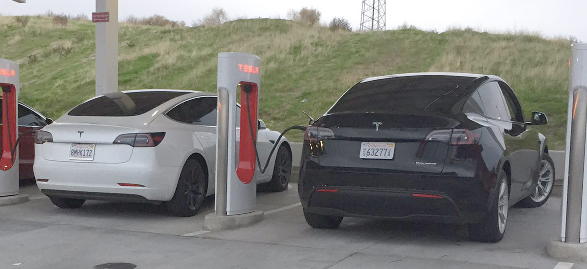 Tesla Model Y and Model 3 charging side-by-side at the Kettleman City Supercharger.