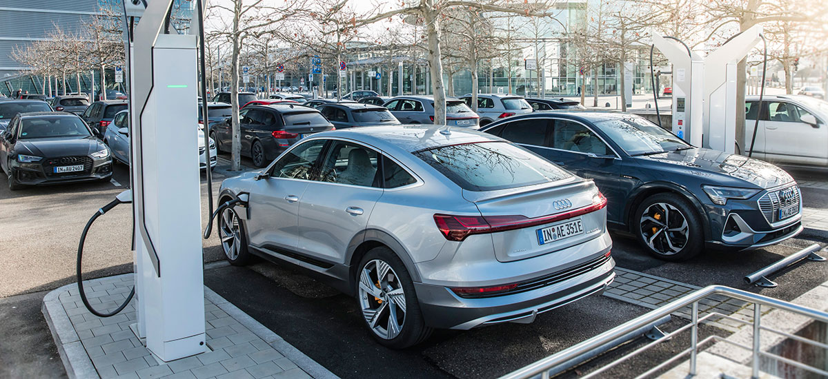 Audi electric cars charging at a proprietary charging station in Germany , automaker plans to invest €100M in charging infrastructure.