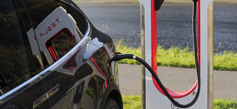 Tesla Model X Electric Vehicle charging at a Tesla Supercharger.