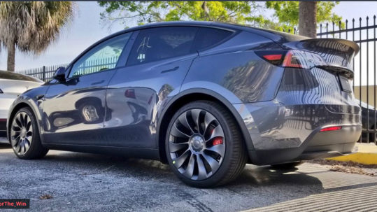Tesla Model Y SUV in Midnight Silver Metallic (gray) color at the Tesla HQ delivery center.