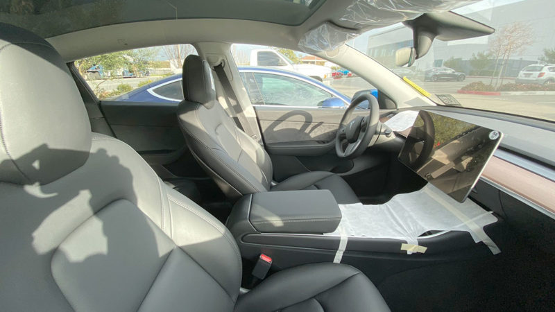 Tesla Model Y interior - first row seats and center touchscreen.