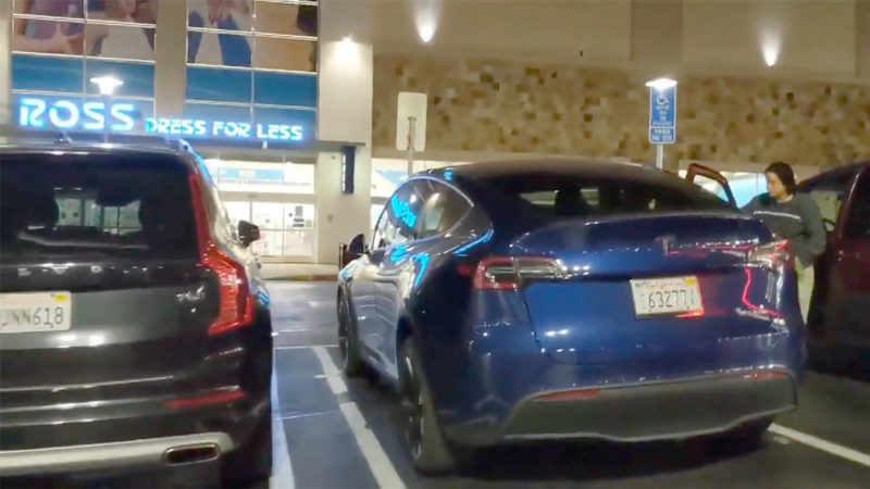 Tesla Model Y parked side-by-side with a Volvo XC90 mid-sized luxury SUV.